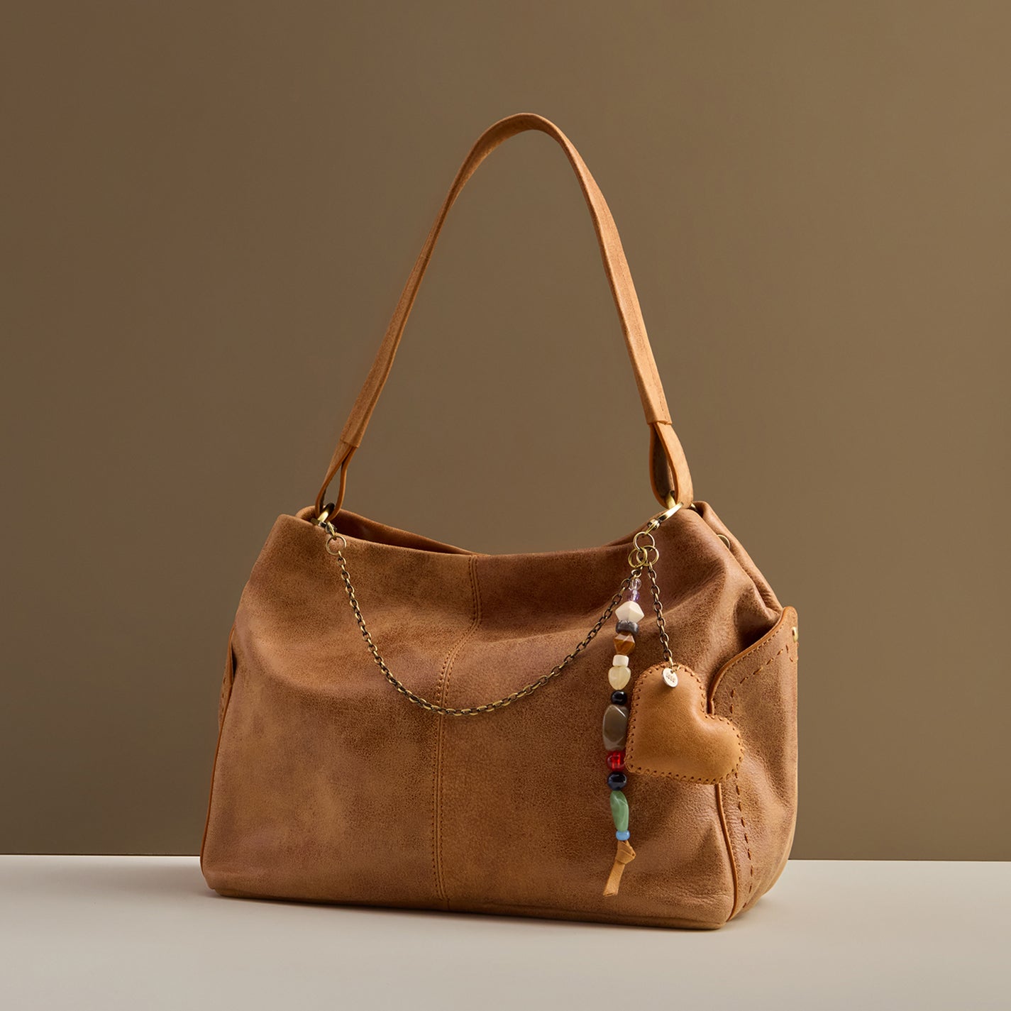 Heart Swells Charm in Buffed Leather – Whiskey - HOBO